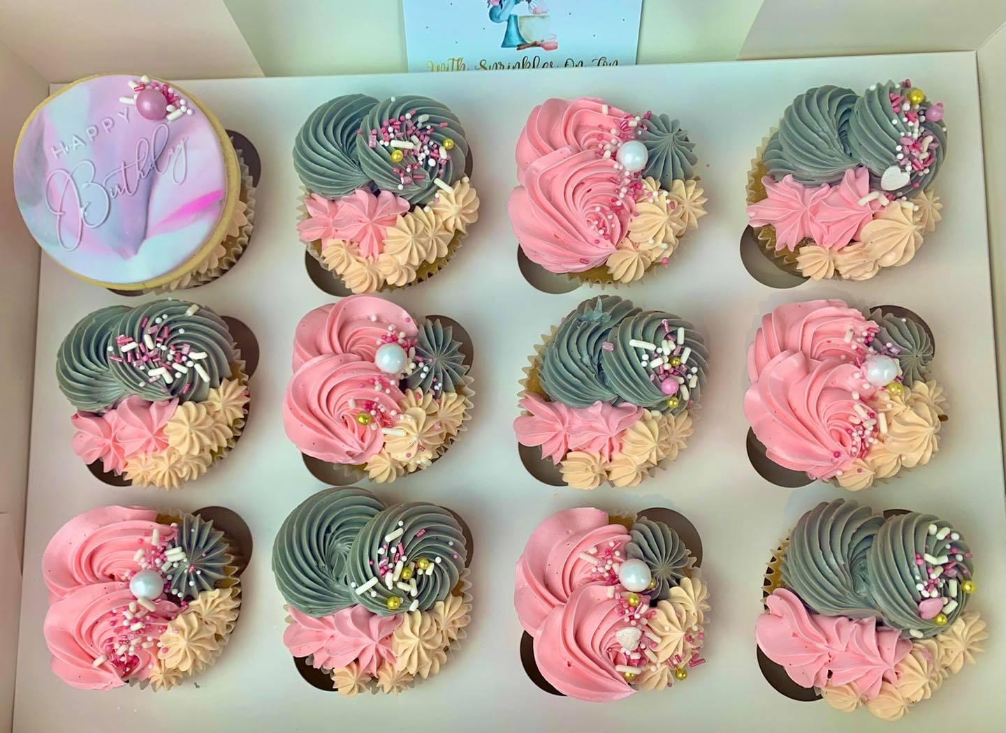 Close-up of piped buttercream swirls on a boxed cupcake order